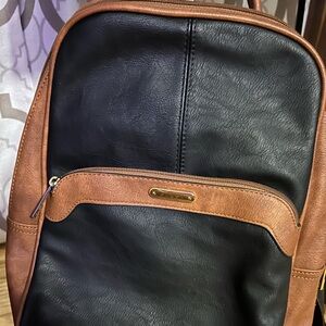 Black and brown leather like backpack.